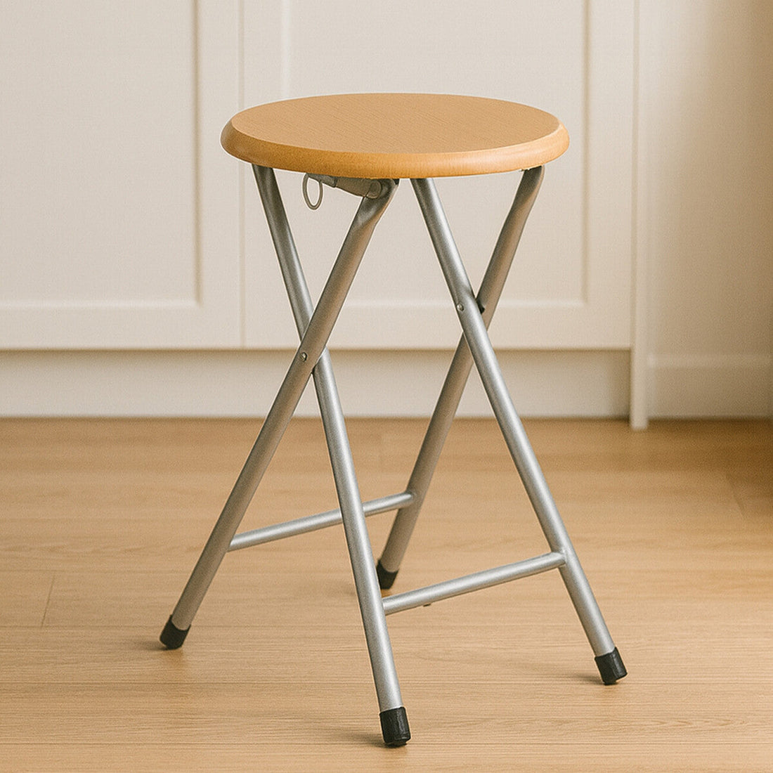 Orsina Hinata folding stool with wood veneer seat shown open and in use in a modern interior setting