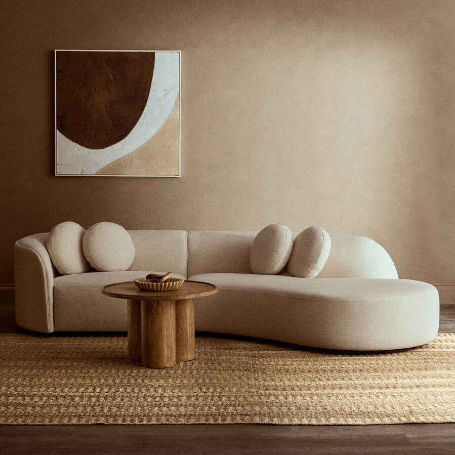 Orsina Ovada 3 Seater Curved Sofa in cream linen upholstery styled in a bright modern living room