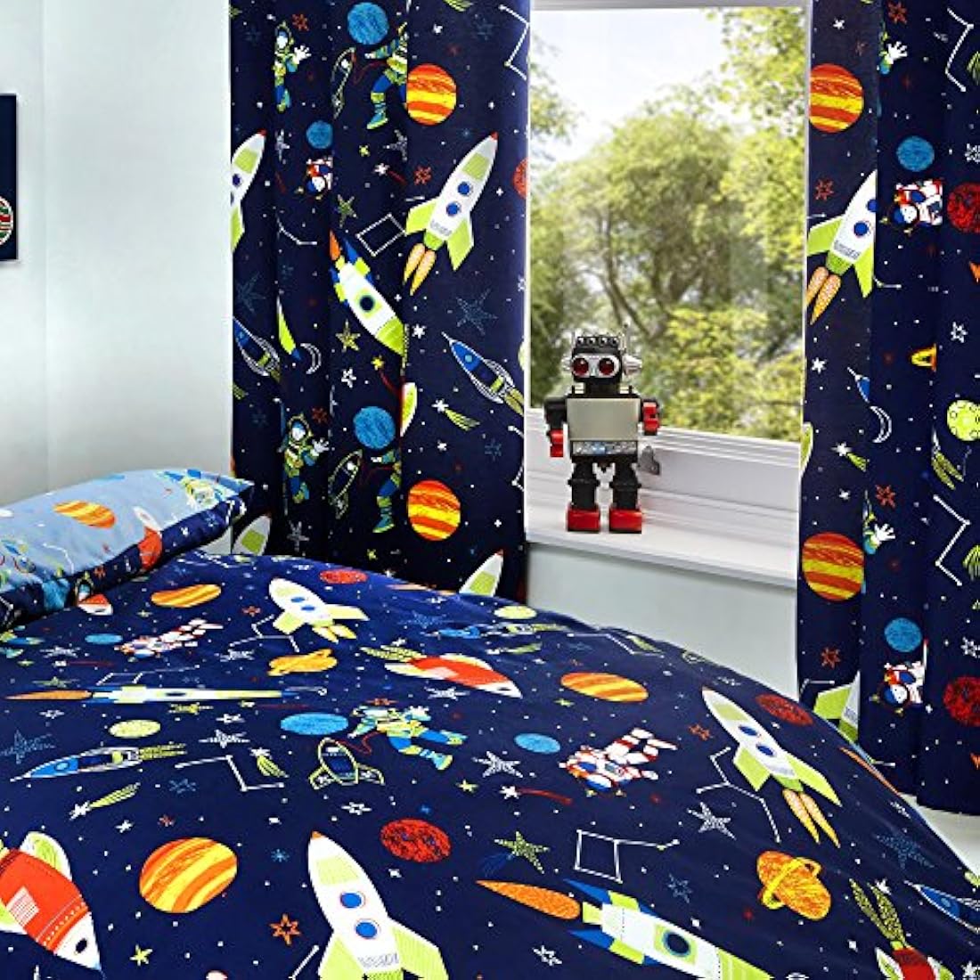 Bedlam Supersonic Glow in the Dark Kids Space Curtains in blue, 66x72, hanging in a child's bedroom with rocket and planet print
