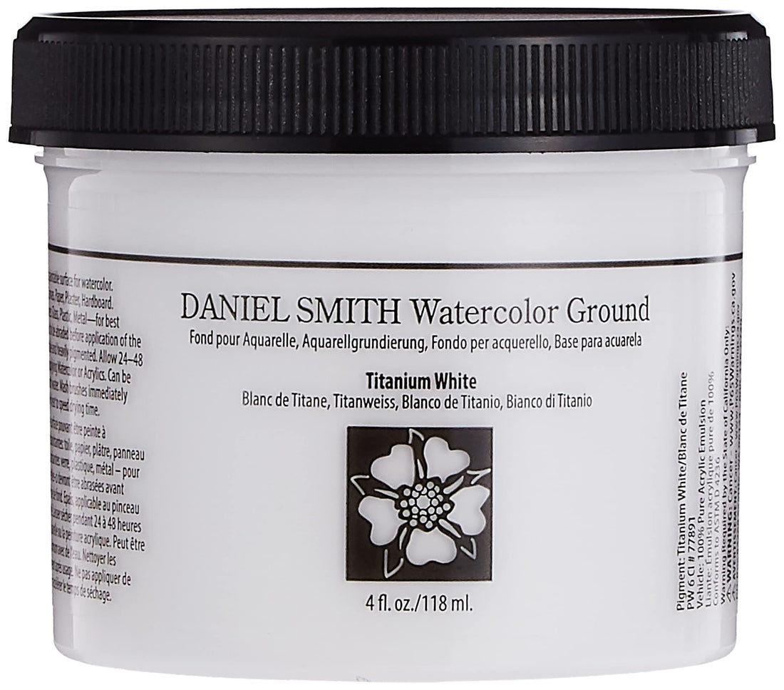 Daniel Smith Watercolor Ground Titanium White 4oz jar on an artist's studio desk surrounded by brushes and watercolour swatches