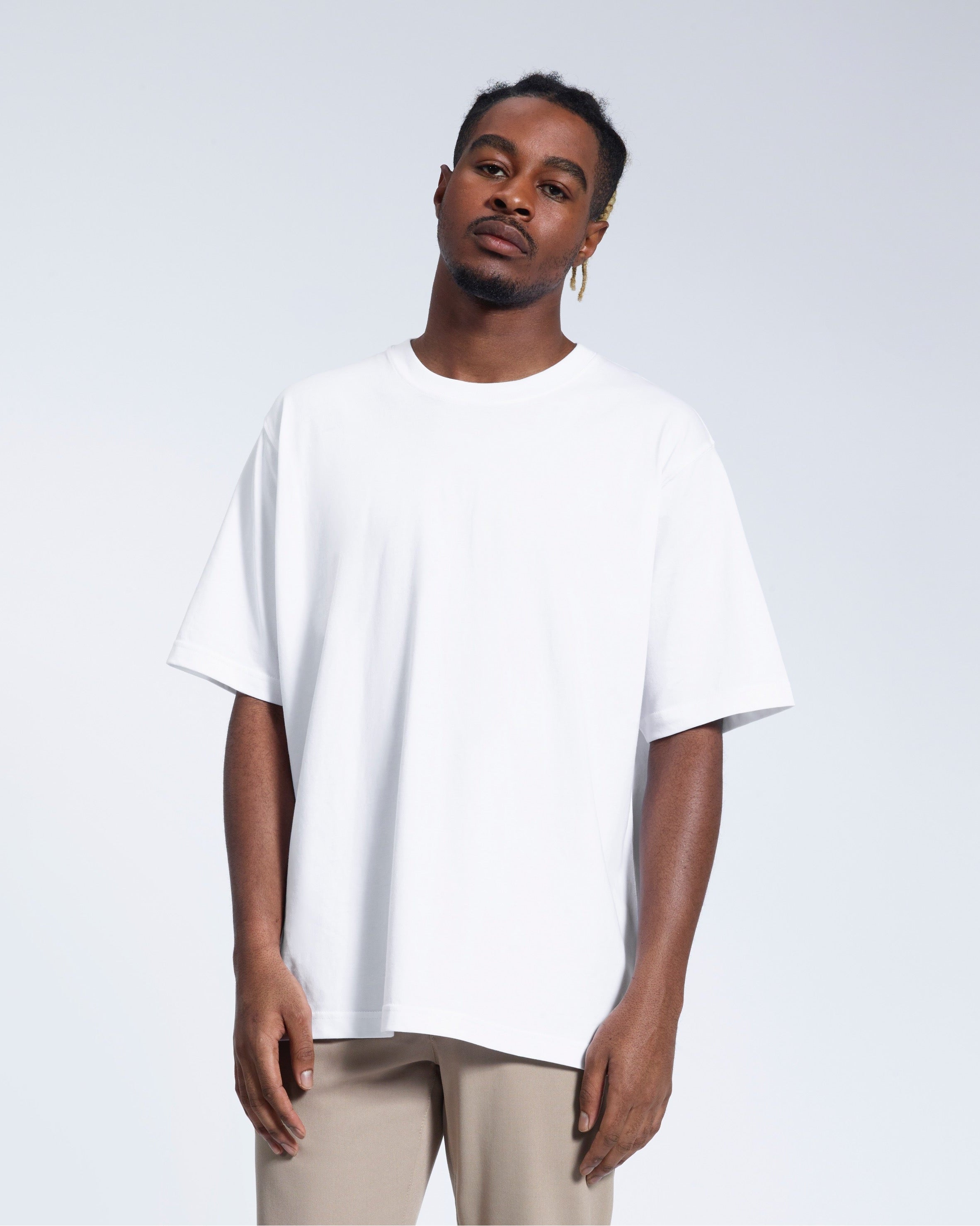 PLAINANDSIMPLE Oversized Heavyweight Organic T-Shirt in white — front lifestyle view showing relaxed oversized fit with dropped shoulders and classic crew neck in 250GSM GOTS-certified organic cotton