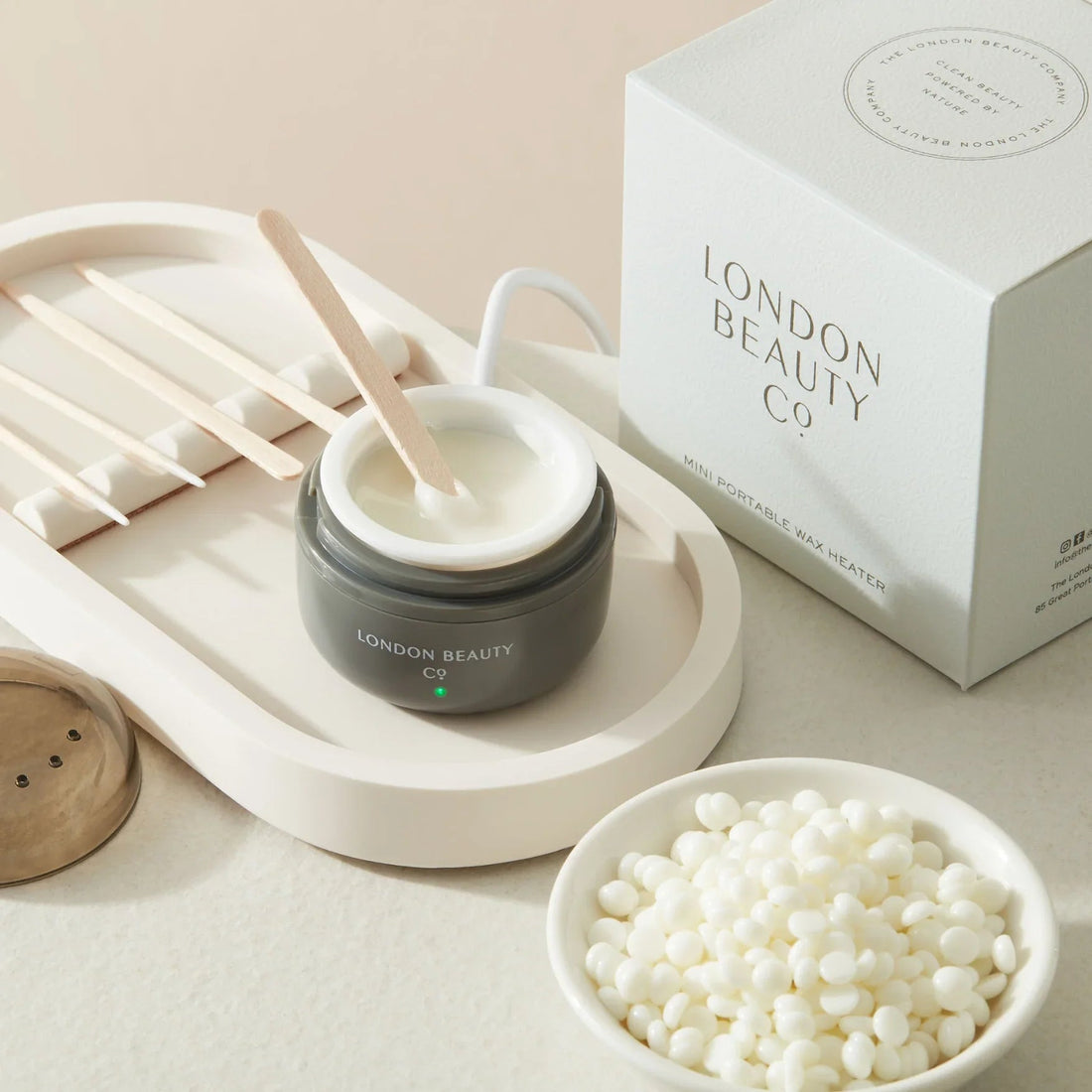 The London Brow Company Mini USB Wax Heater – portable facial waxing kit showing compact heater unit with USB cable, wax beads, spatulas and post-wax wipes