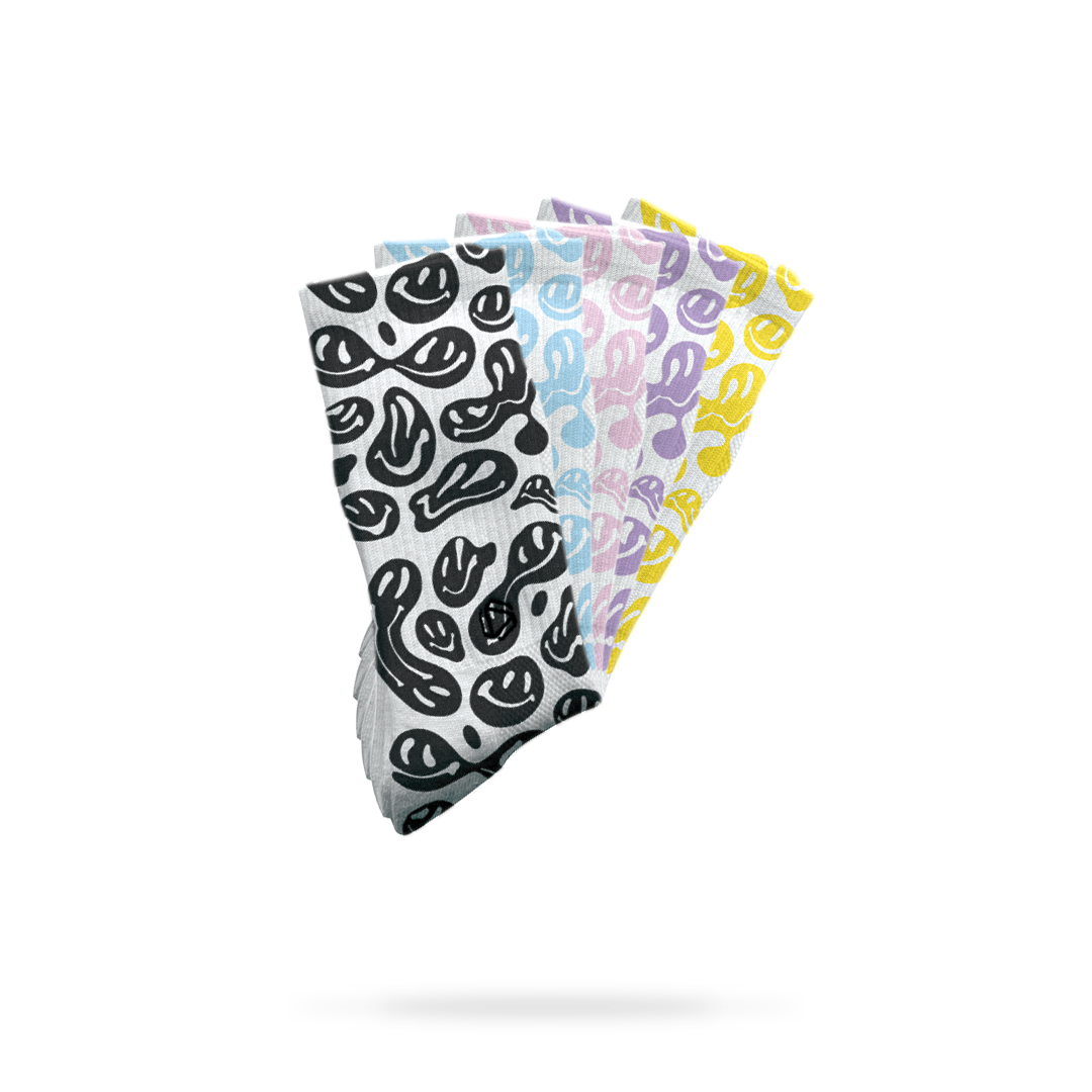 HEXXEE Smiley Socks collection showing the melted smiley face design across multiple colourways including black, pink, blue, mustard and purple