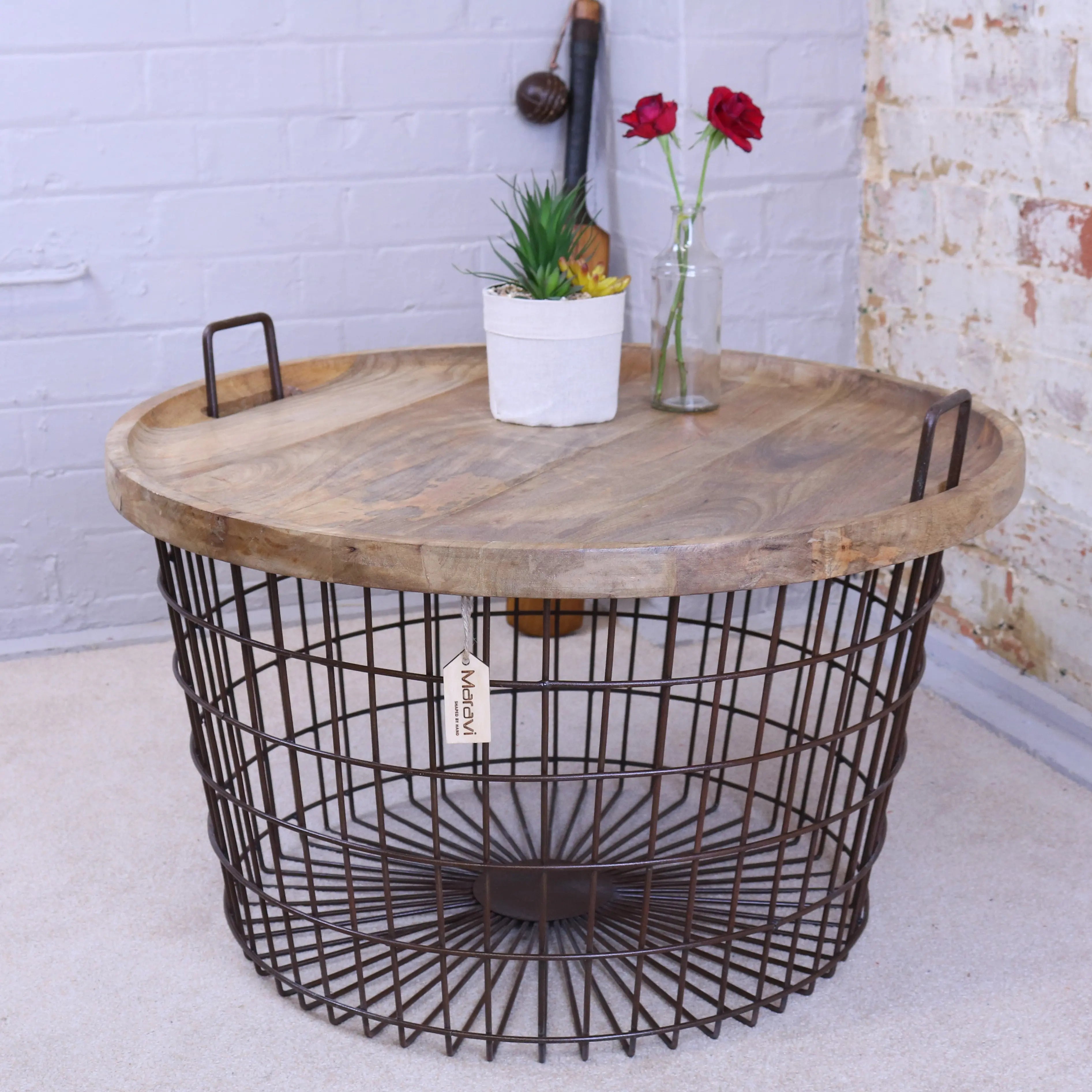 Tilpi Industrial Basket Table with mango wood lid and rusted steel mesh basket, styled in a living room as a side table