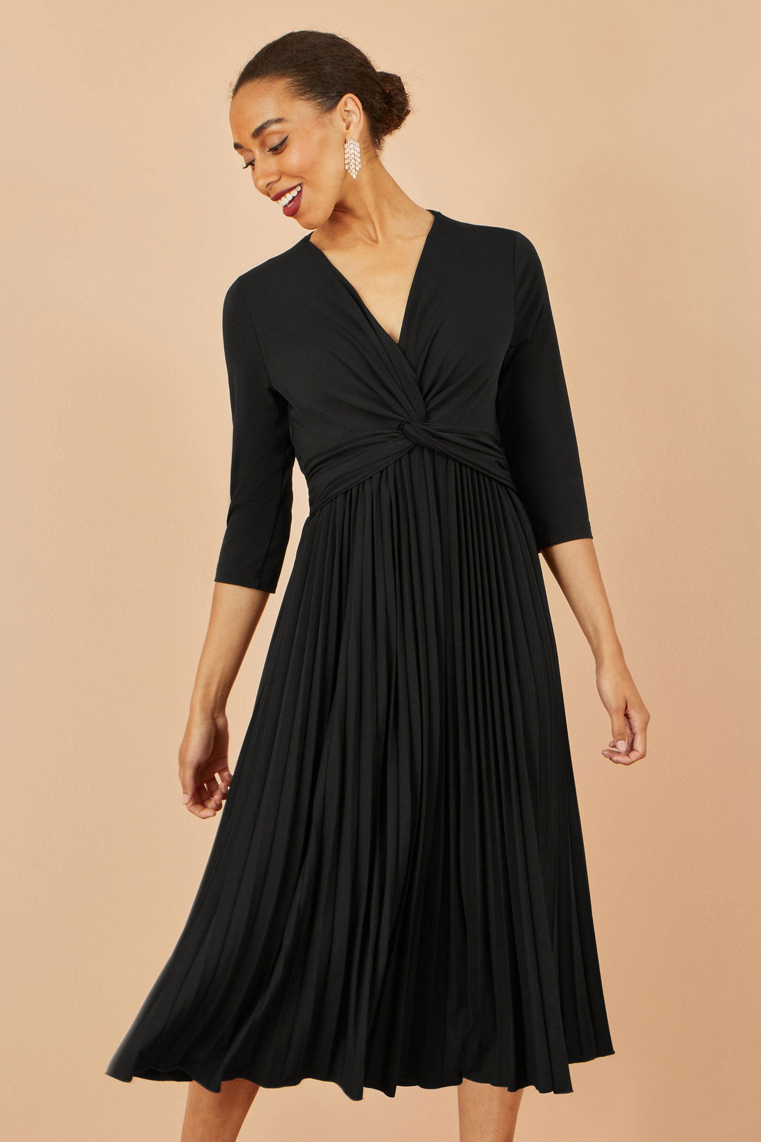 Yumi Black Jersey Knot Waist Pleated Midi Dress — the elegant, versatile dress that became Simone Hartley's most-reached-for piece for every occasion from work dinners to winter weddings