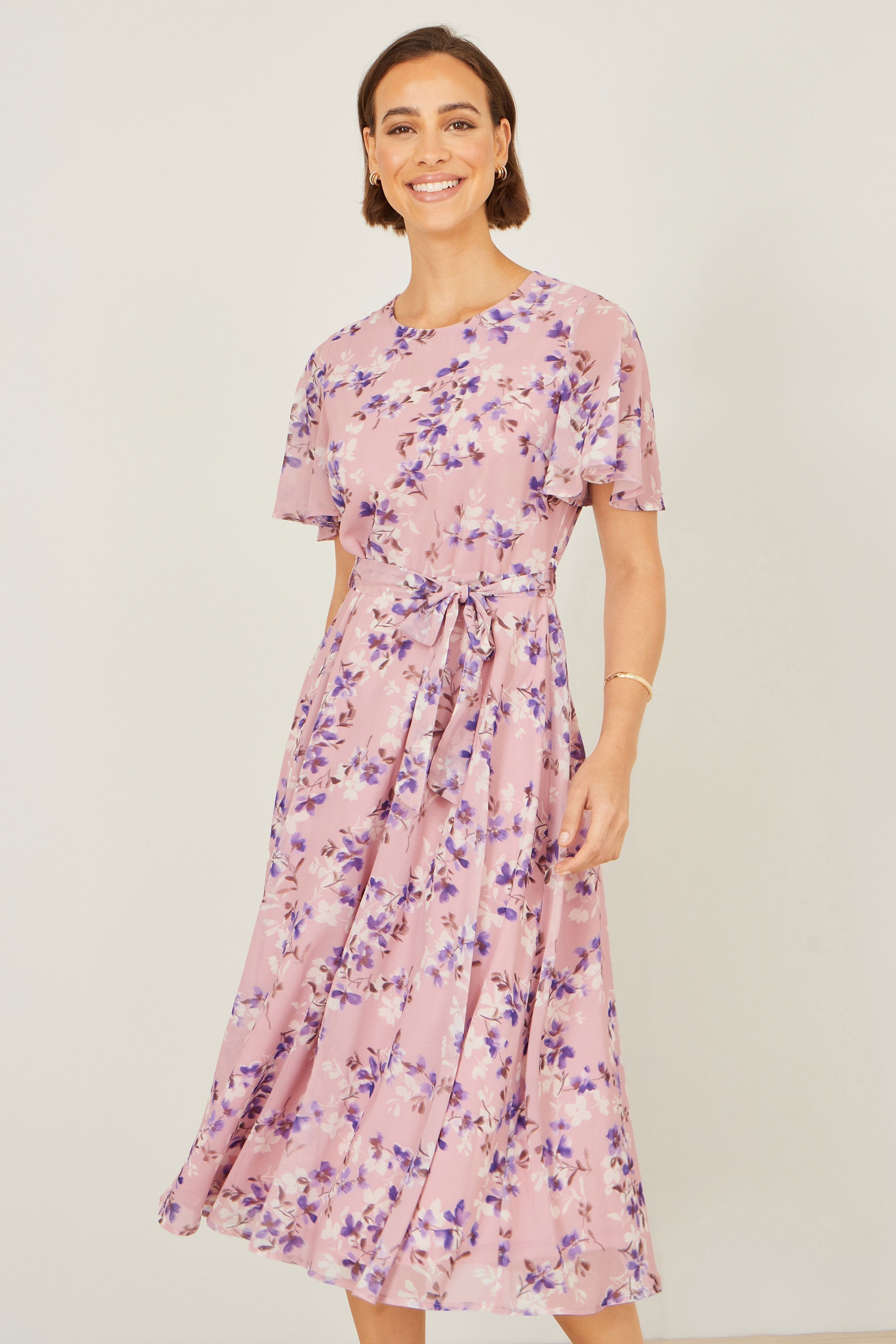 Yumi Pink Blossom Skater Midi Dress with Angel Sleeves — soft pink floral print midi dress with flutter sleeves and adjustable tie waist, full length front view