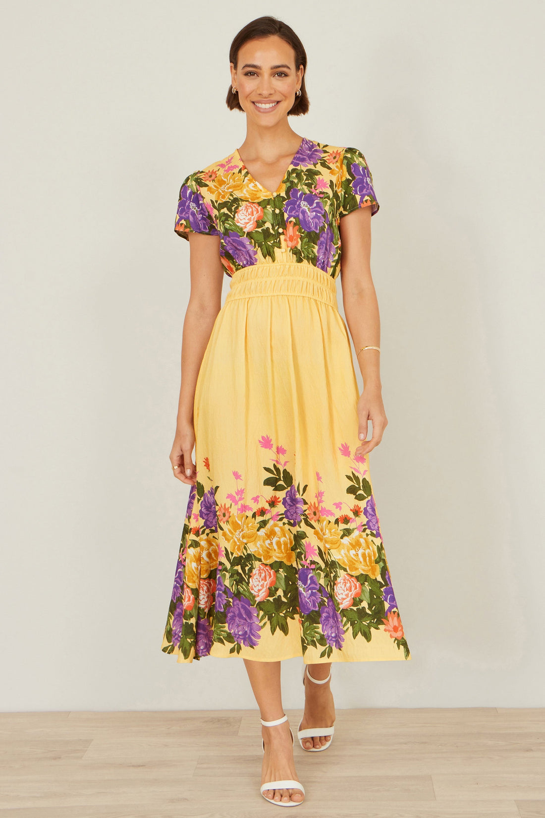 Yumi Butter Yellow Floral Mirror Print Viscose Midi Dress – vibrant butter yellow dress with rich floral print in purple, pink, green and golden tones, ruched waist and flowy midi skirt
