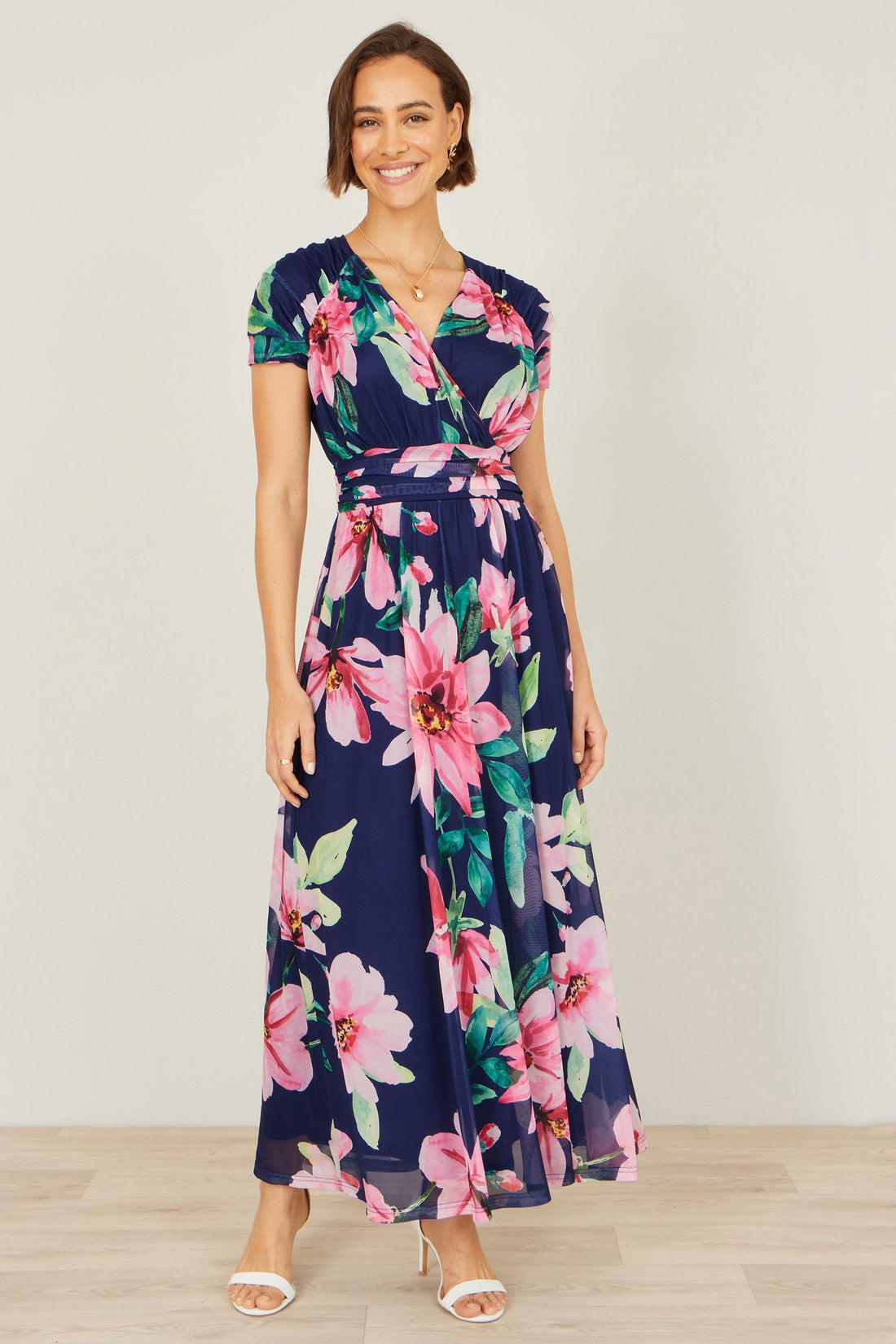 Yumi Navy Mesh Floral Maxi Dress — bold pink and green floral print on deep navy mesh, faux-wrap bodice with ruched shoulders and defined waist, 143cm length flowy skirt