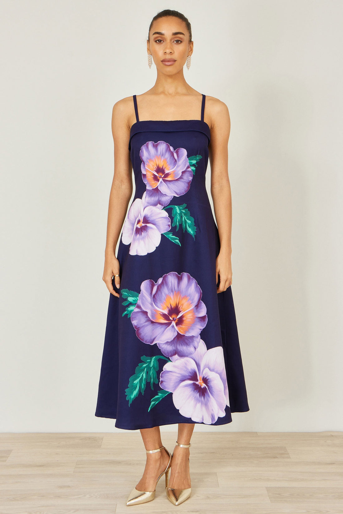 Yumi Navy Pansy Strappy Midi Dress — 100% polyester sleeveless strappy midi dress with bold placement pansy floral print, softly flared skirt and slim straps at 126cm length