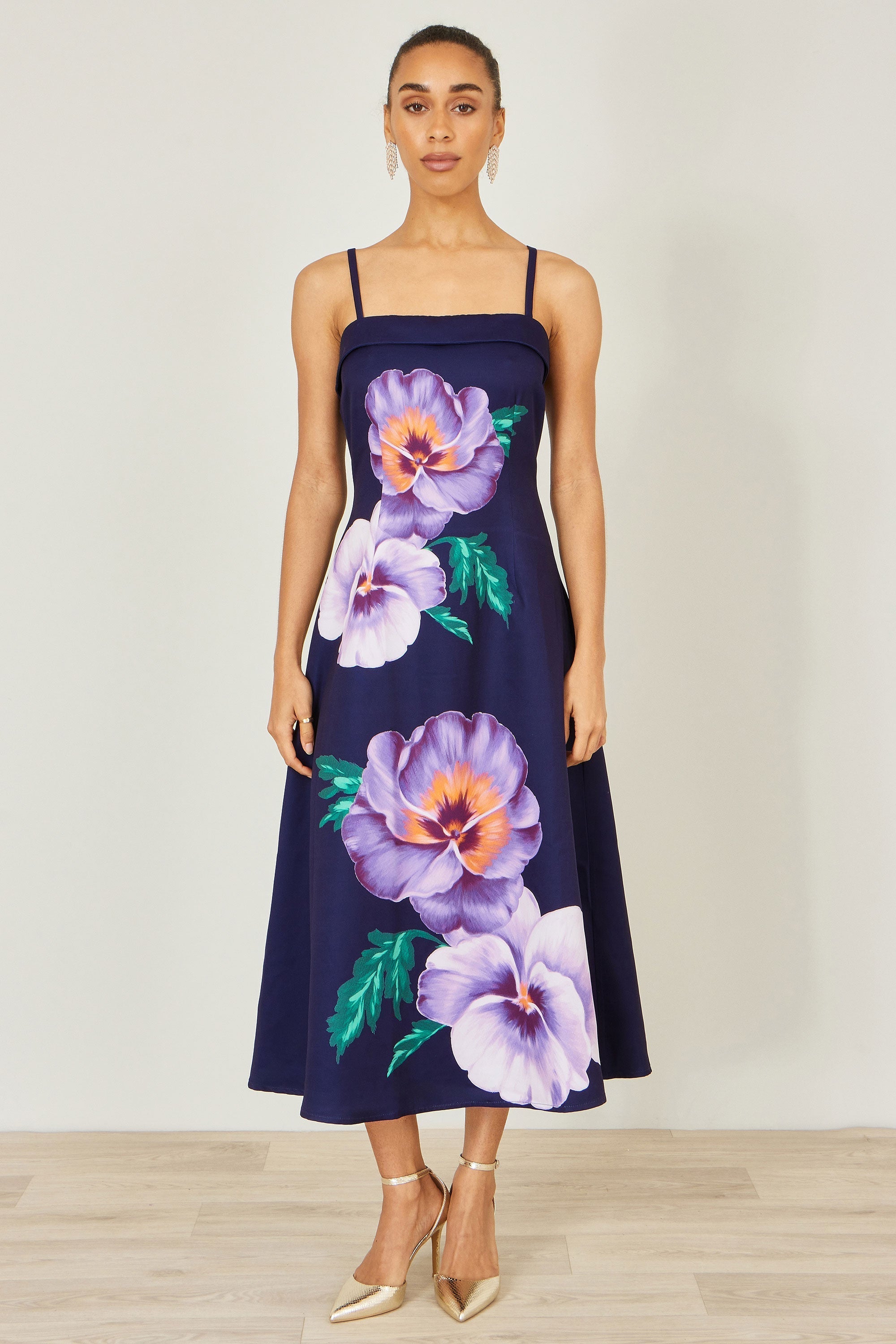 Yumi Navy Pansy Strappy Midi Dress — 100% polyester sleeveless strappy midi dress with bold placement pansy floral print, softly flared skirt and slim straps at 126cm length