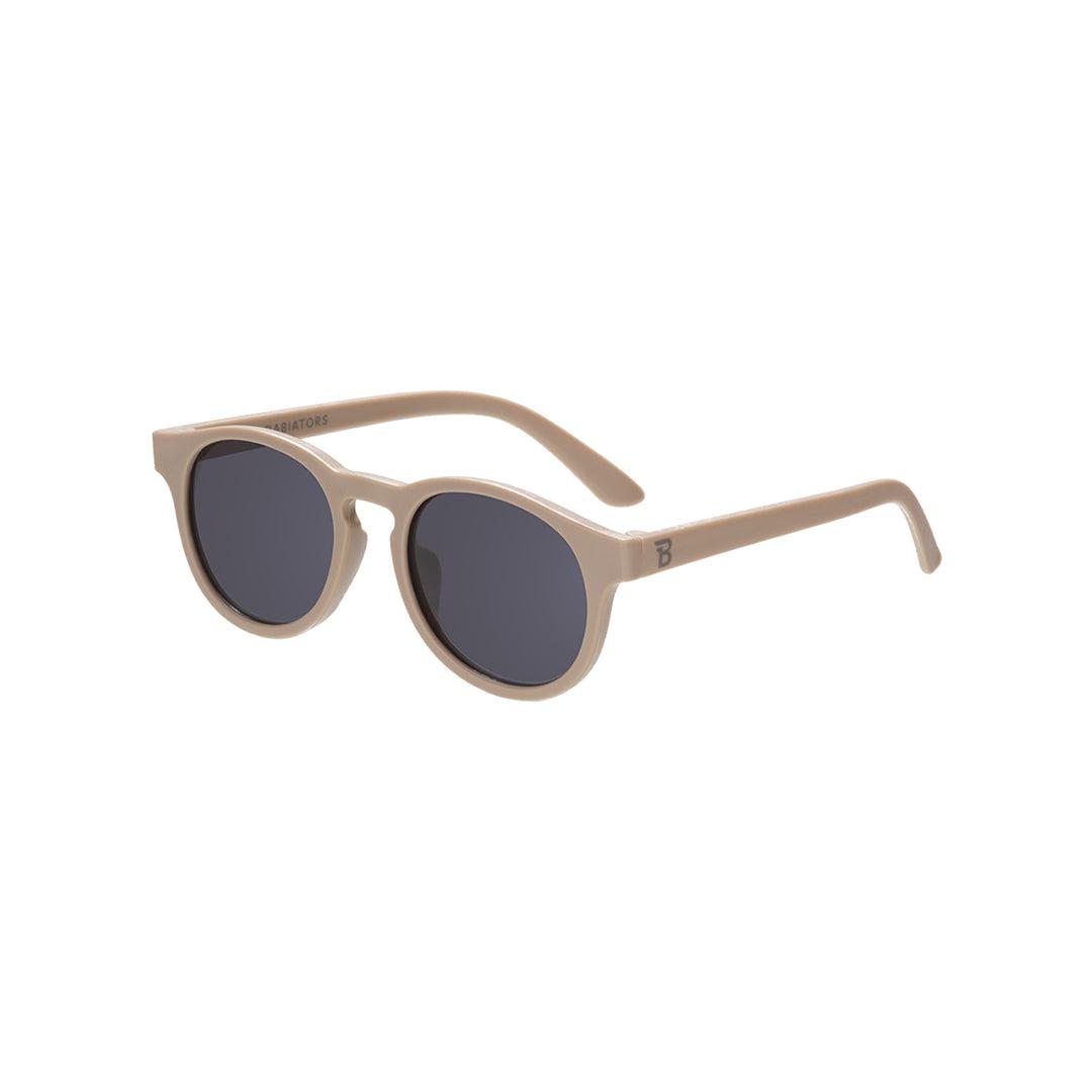 Babiators Eco Keyhole Kids Sunglasses in Soft Sand — made from 100% recycled ocean-bound plastic with UV protection, shown in the neutral soft sand colourway