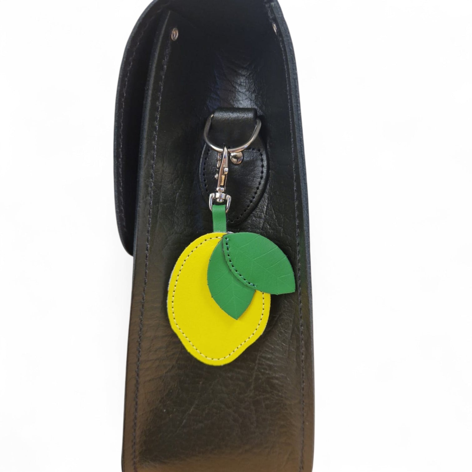 Handmade Leather Fruity Bag Charm in Lemon by Zatchels attached to a handbag strap showing the bright yellow hand-cut leather lemon with stalk and clip, handmade in England
